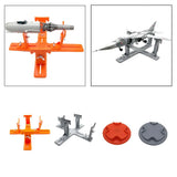 Model airplane painting tool kit with orange stand, gray base, and round paint pads