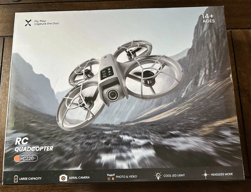 RC quadcopter drone on retail box packaging, aerial camera and LED lights shown
