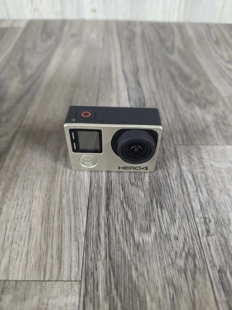 GoPro HERO4 action camera with front lens and small display on silver body