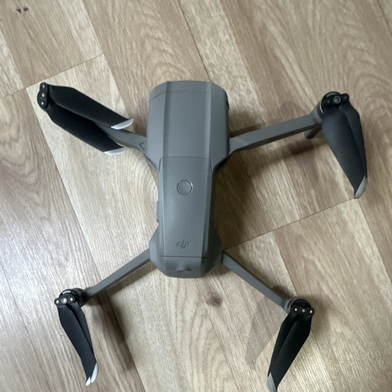 DJI Mavic camera drone with four propellers, gray body and folded arms