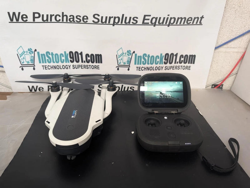 White quadcopter drone with 4 rotors and black controller with screen