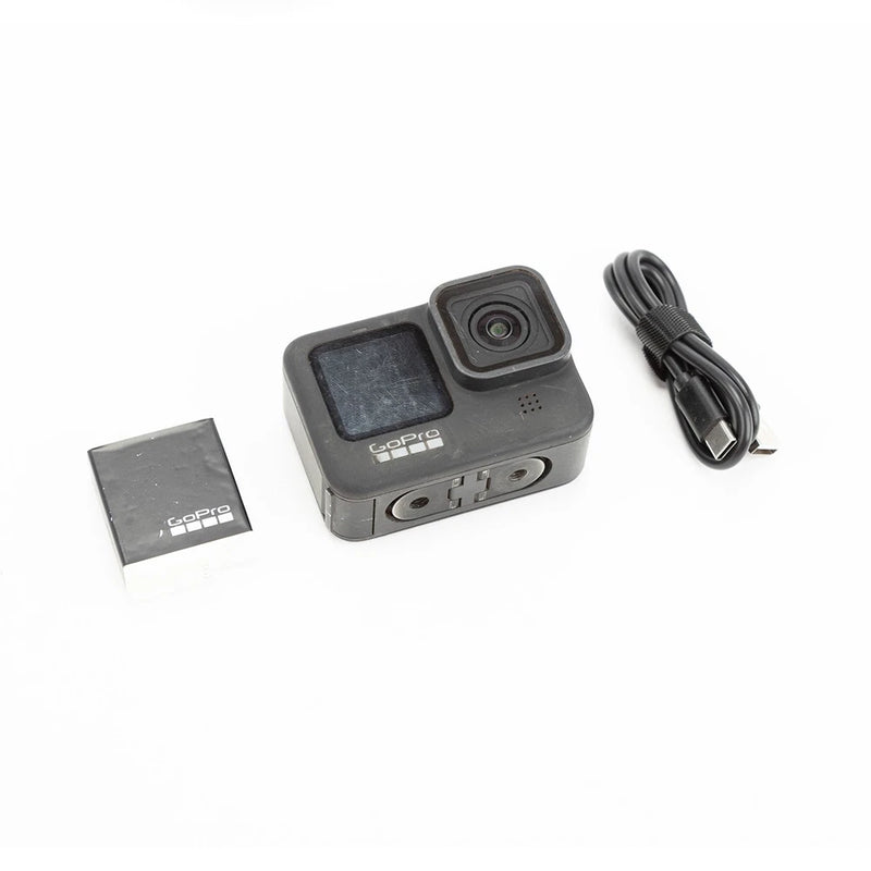 GoPro HERO9 Black action camera with front lens, side screen, and USB cable
