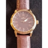 Invicta round gold-tone watch with brown leather strap and dark dial