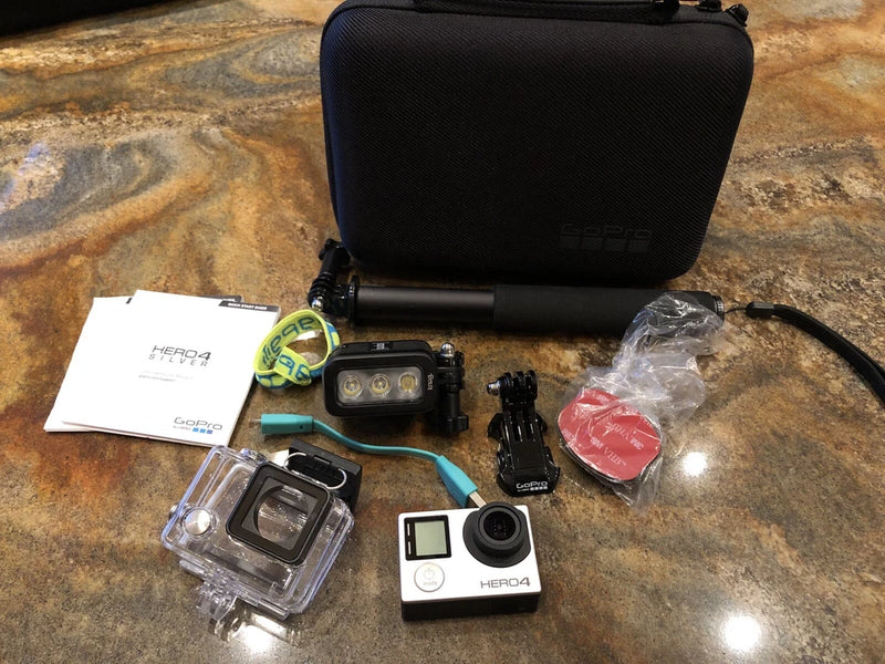 GoPro HERO4 action camera kit with waterproof housing, mounts, and accessories in case
