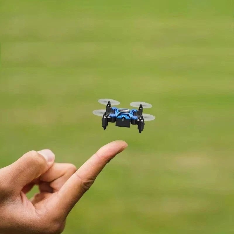 Mini quadcopter drone with camera, four propellers in flight