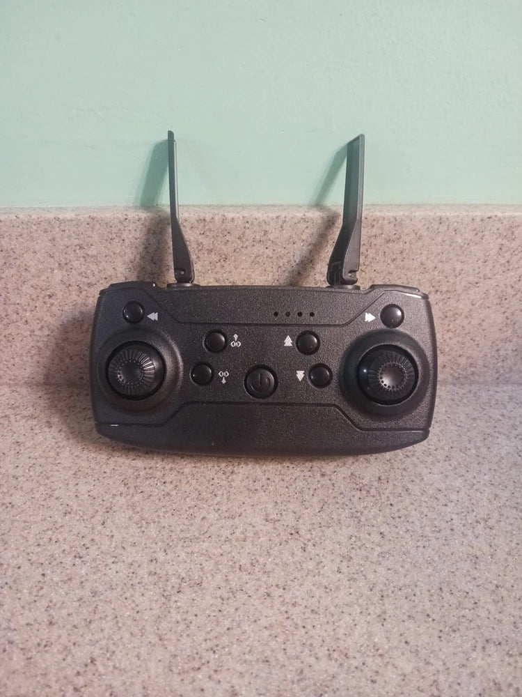 Black wireless handheld drone controller with dual antennas and dual joysticks