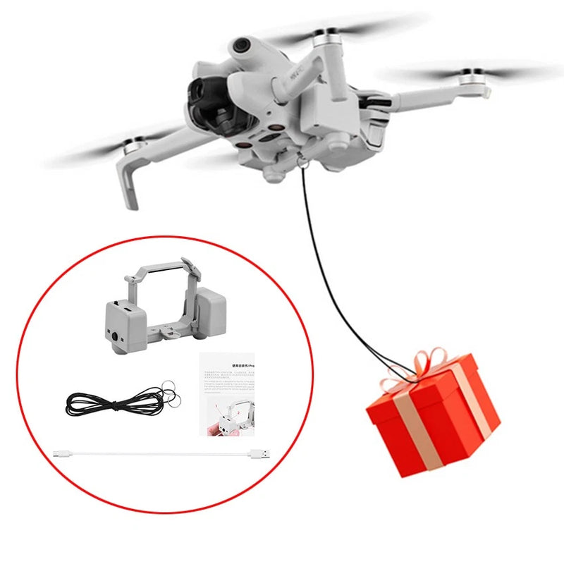 White gift-launcher drone accessory with cable, small controller, and gift box