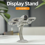 White desktop drone display stand for DJI NEO, curved bracket with platform