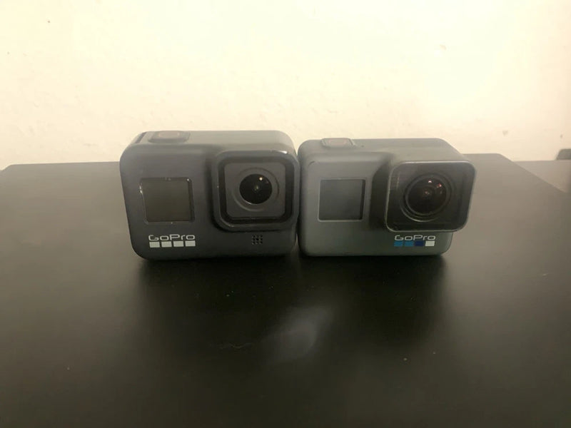 GoPro action cameras with dual lens, shown side by side in gray protective cases