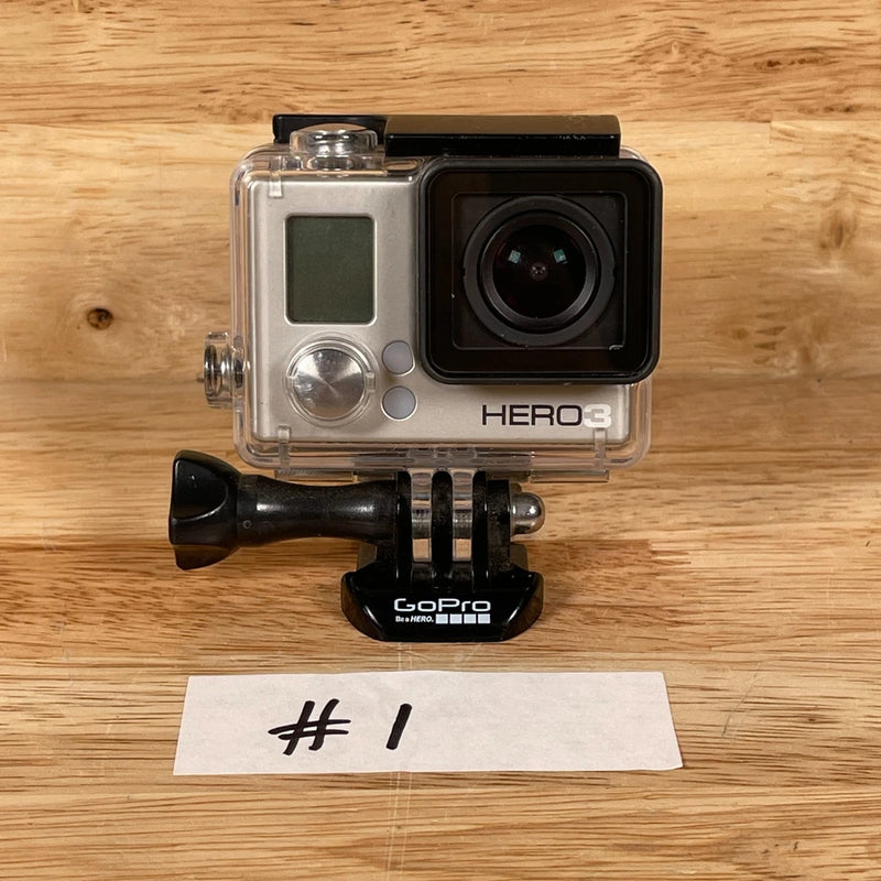 Silver action camera with front lens and HERO3 label, in clear protective case