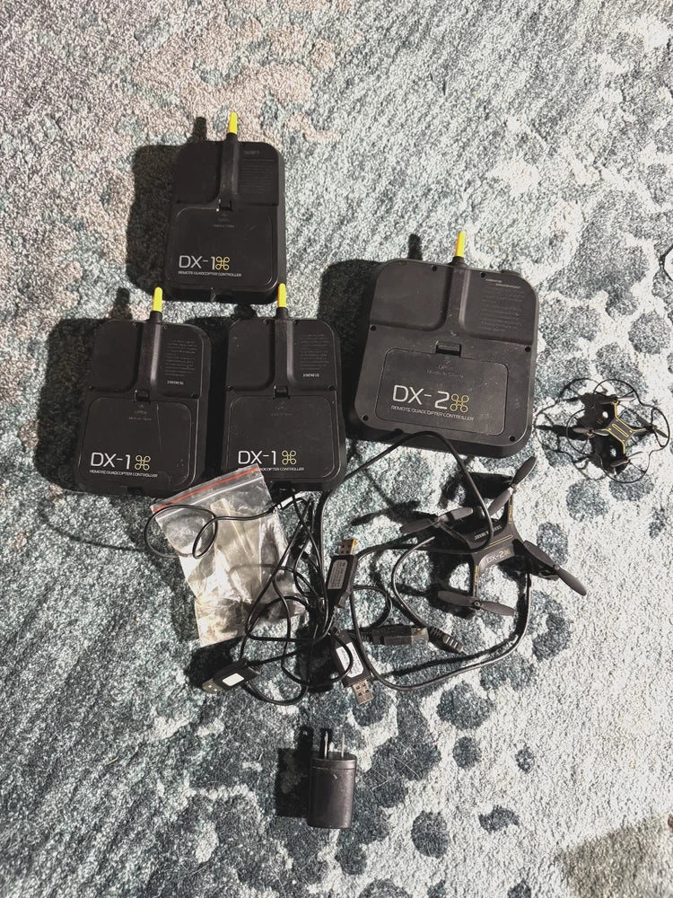Micro drone lot with DX-1 remote controllers, charging cables, and battery packs