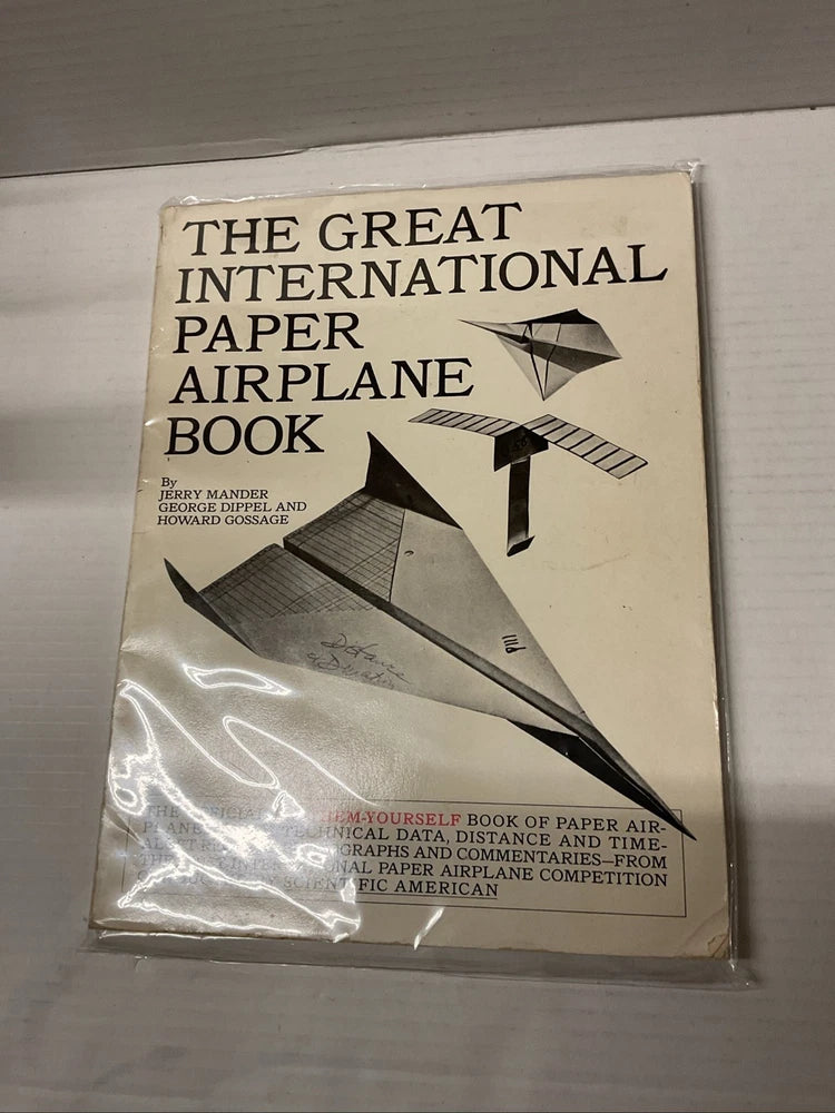 Paper airplane how-to book with illustrated plane on vintage beige cover