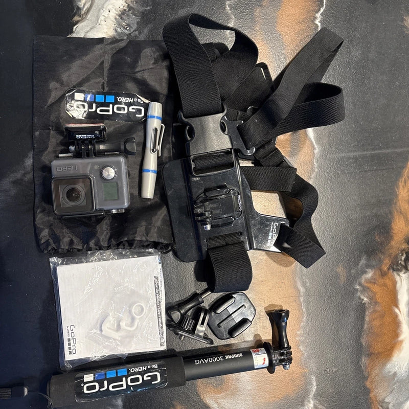 GoPro waterproof action camera kit with camera housing, straps, mounts, and accessories