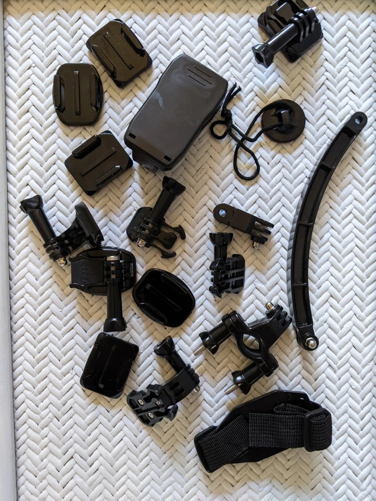 Action camera accessory kit with multiple mounts, straps, protective cases and adapters