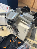 Light gray quadcopter drone with front camera and visible propellers