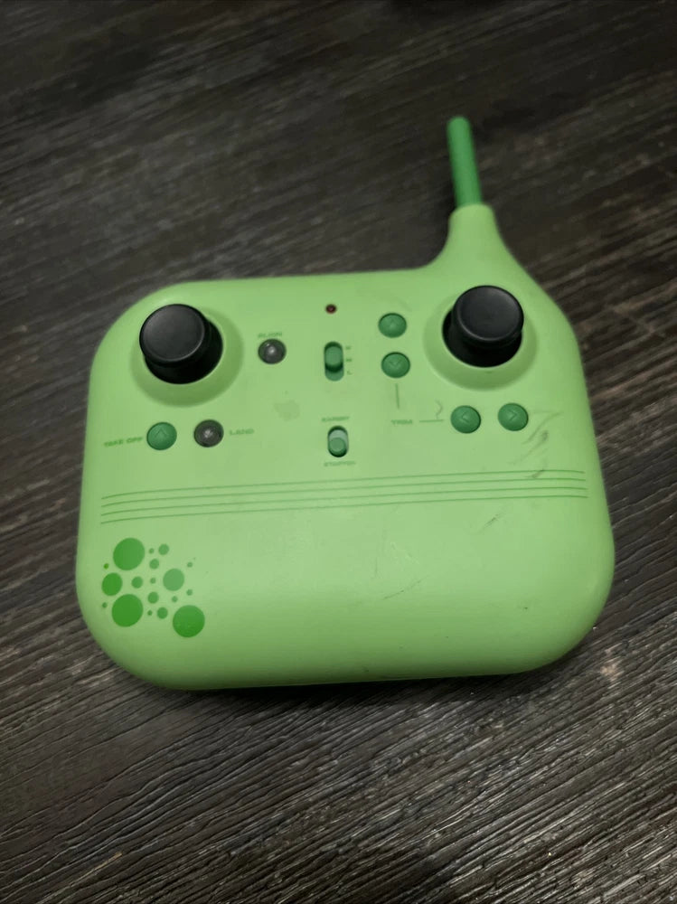Green remote control with dual joysticks and buttons for stunt drone