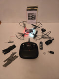 Black quadcopter RC drone with illuminated LEDs and remote controller, plus batteries and parts