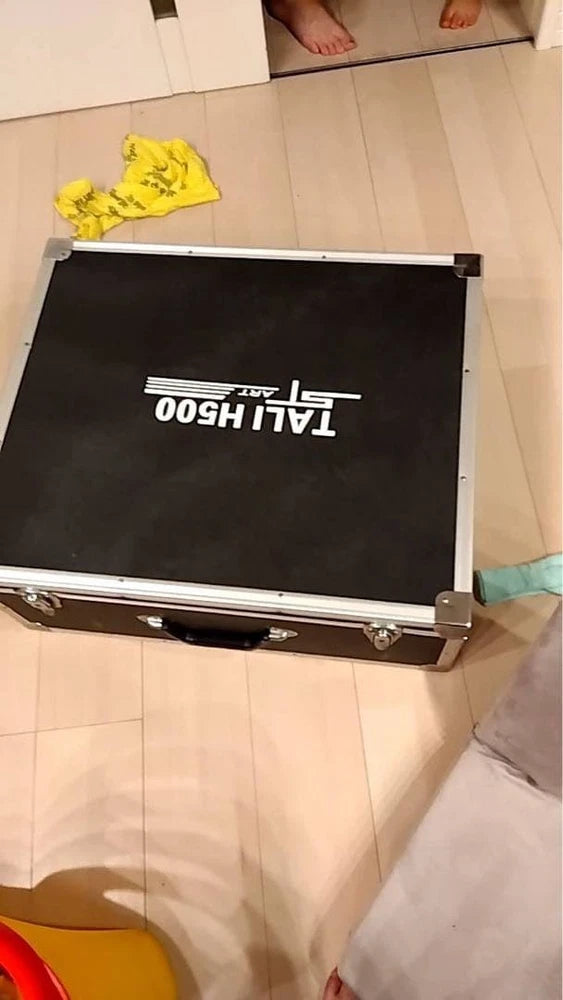 Black hard-shell drone transport case with white lettering, top lid open