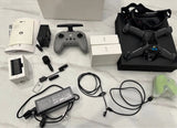 FPV drone kit with quadcopter, controller, goggles, cables, and power adapters