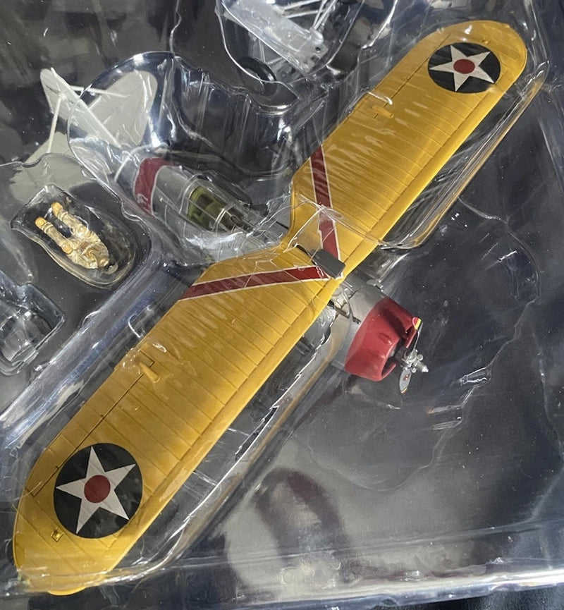 Yellow airplane model with red tail and propeller, detailed WWII markings