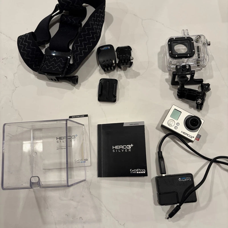 GoPro HERO3+ Silver action camera kit with waterproof housing, mounts, cables, and case