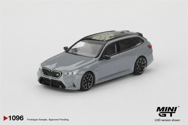 Grey metallic wagon model car with front grille and headlights, side profile view