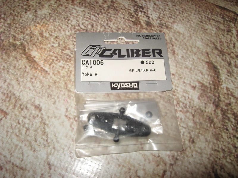 Kyosho RC helicopter spare part yoke in clear plastic bag, CA1006 label