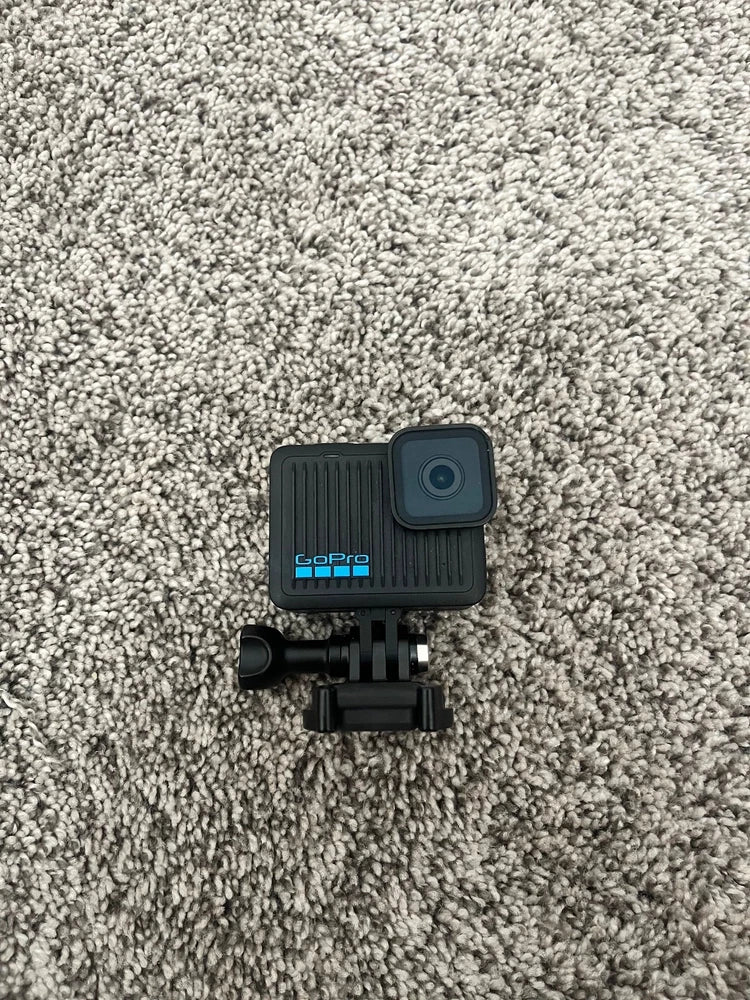 Used GoPro HERO action camera with mounting bracket, black body