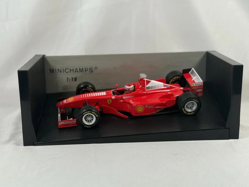 Minichamps 1:18 die-cast Ferrari race car model in red, displayed in black box