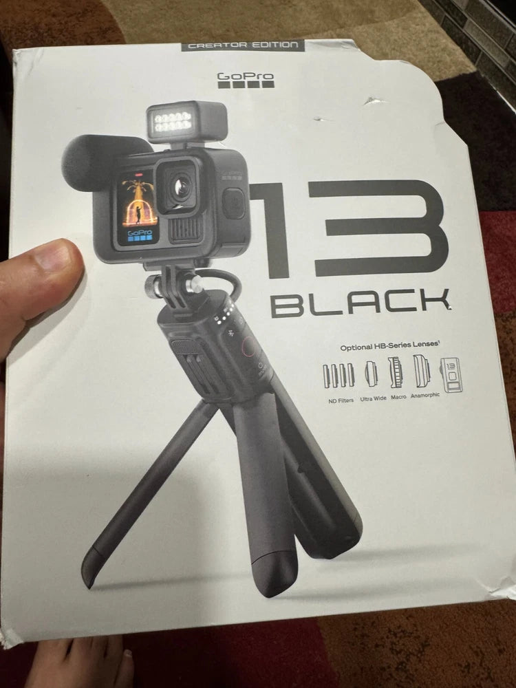 GoPro HERO13 Black action camera with handle mount, shown on retail box