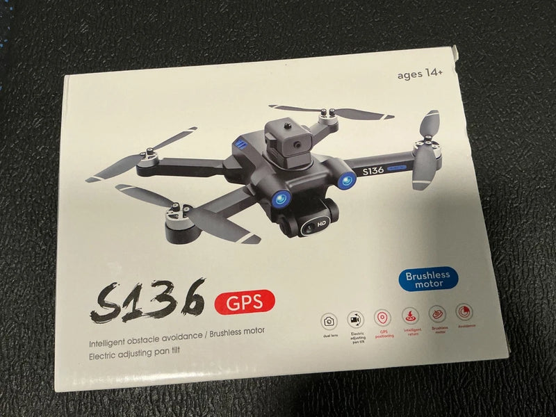 GPS mini drone on box, gray quadcopter with four propellers and front camera