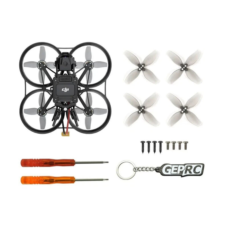 FPV racing drone kit with quadcopter, four propellers, screwdrivers, and keychain