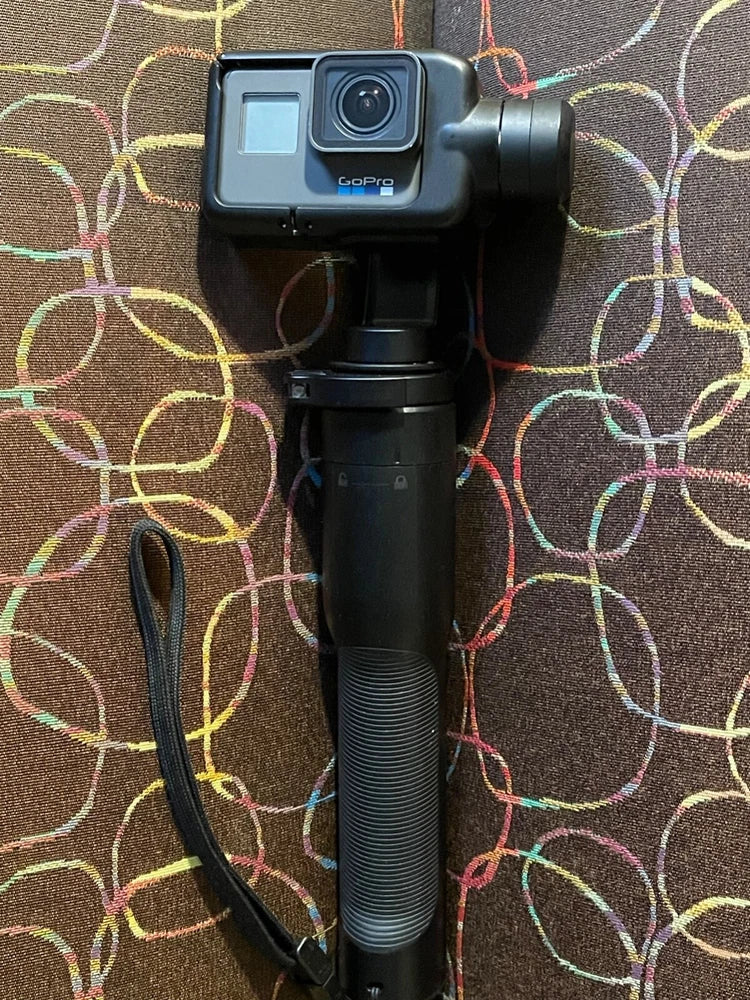 GoPro HERO6 action camera on handheld gimbal, front lens and touchscreen visible