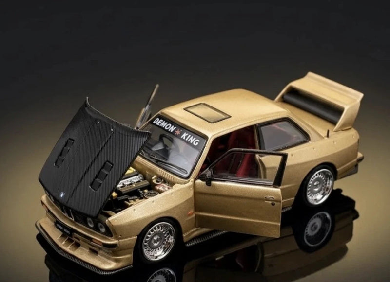 Beige die-cast model car with hood open, showing engine, front three-quarter view