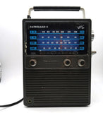 Vintage Realistic Patrolman-4 portable AM/FM VHF radio, black front with tuning knobs