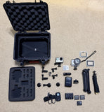 GoPro HERO4 action camera kit in open hard case with mounts, battery, and accessories