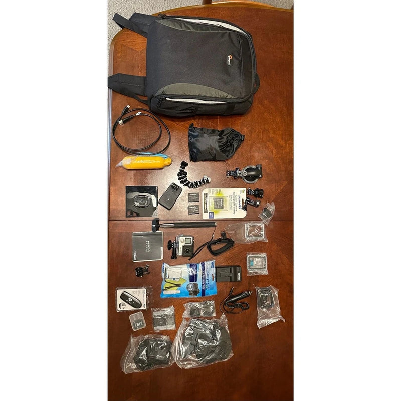 Dark gray camera accessory bag with assorted mounts, cases, and small gadgets