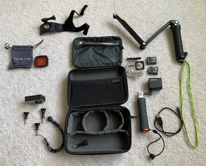 GoPro HERO4 action camera kit with open waterproof case and mounting accessories