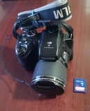 Fujifilm FinePix digital camera with extended lens, wrist strap, and 16GB SD card
