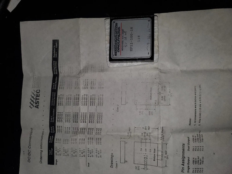 DC-to-DC converter module with label and printed electrical specs diagram on it
