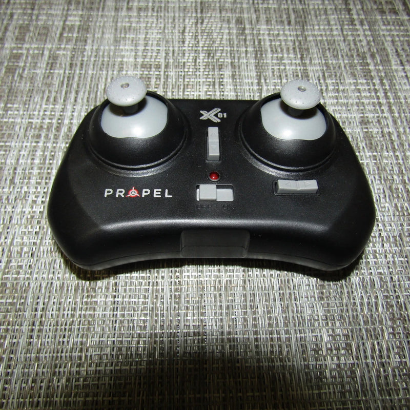 PROPEL X01 micro drone controller with two black thumbsticks and center buttons