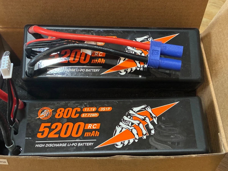 Two black 5200mAh Li-Po RC battery packs with 11.1V 3S1P labels and connectors