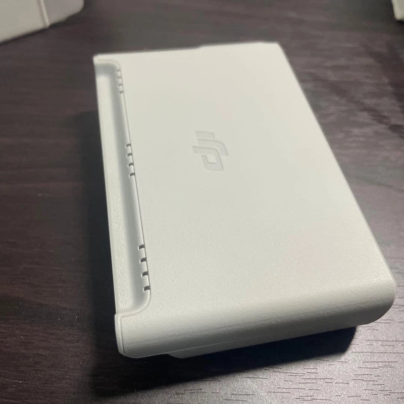 DJI Neo battery charging hub station, light gray rectangular charger with ports
