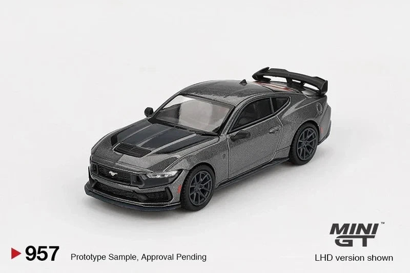 1:64 scale gray sports car model with black hood and racing stripes, front 3/4 view