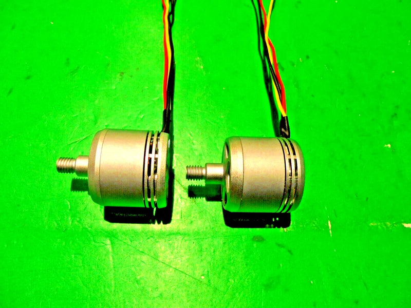 Pair of genuine DJI drone motors with silver housings and output shafts