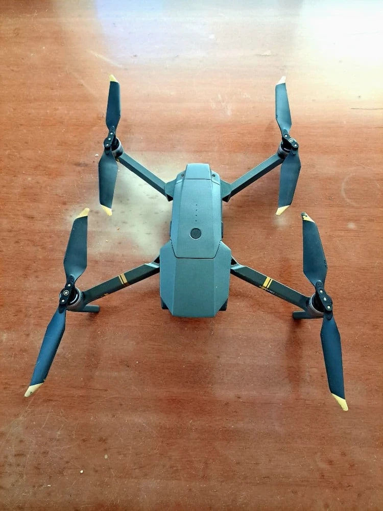 Light blue quadcopter drone with folding prop arms