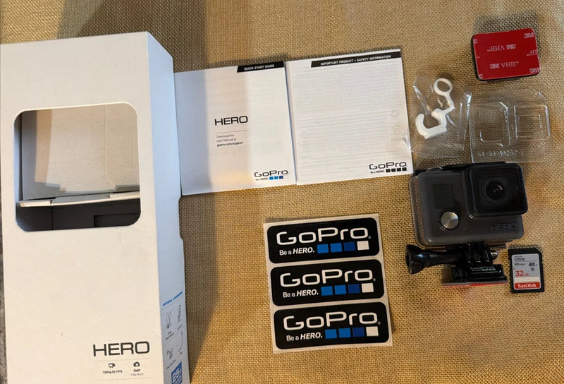 Gray GoPro HERO action camcorder with protective housing and mounting accessories