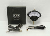Analog DC battery tester voltmeter with meter dial, probe leads, and black storage box