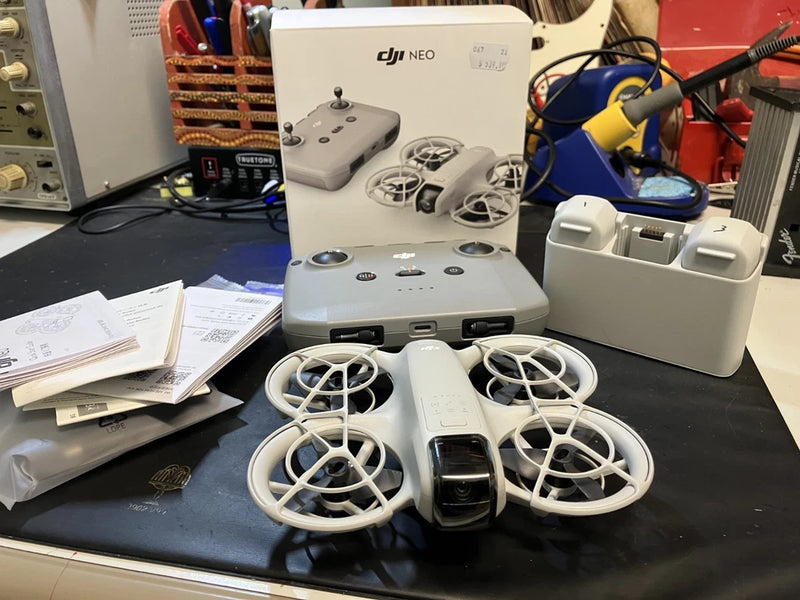 DJI Neo Fly More Combo kit: white drone with spare props, charging hub, controller