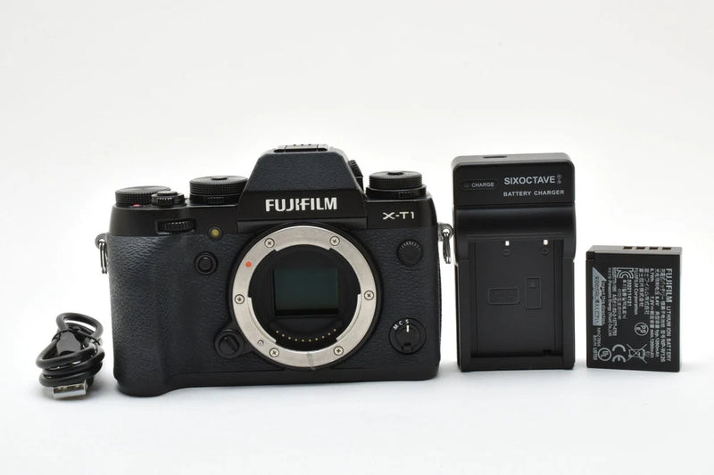 Black Fujifilm X-T1 mirrorless camera body with visible battery and compartment door